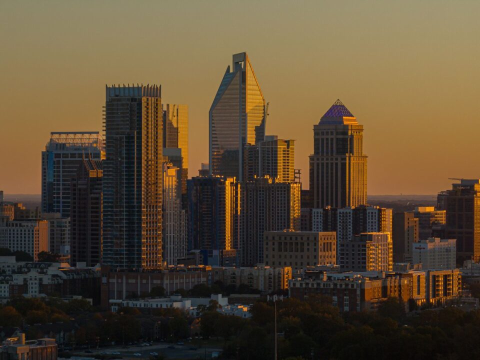 Cover illustration of Charlotte commercial real estate skyline with office, industrial, retail, and multifamily districts